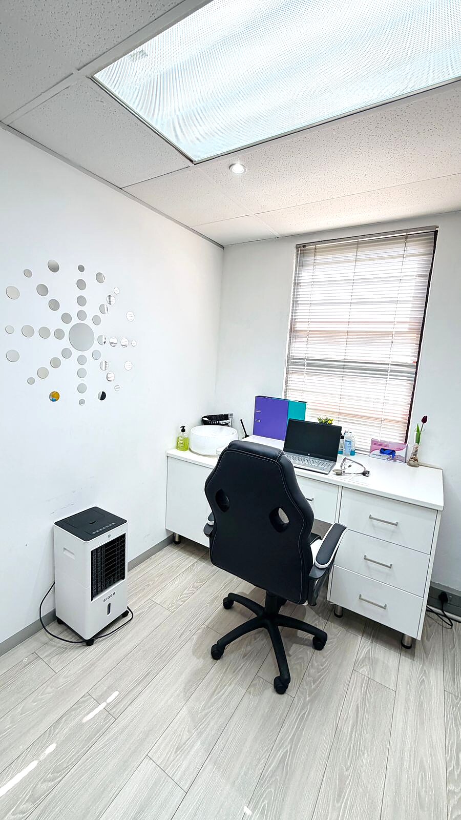Lonehill consultation room with desk, hand basin and clinical equipment