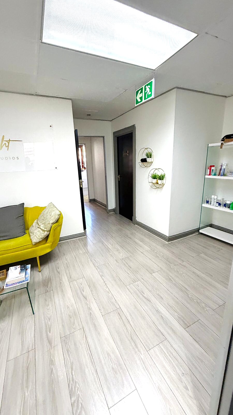 Lonehill reception passage with skincare product display shelves